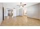 Open main bedroom featuring tan tile flooring, white walls, a ceiling fan, and multiple doorways at 1712 E Manhatton Dr, Tempe, AZ 85282