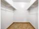 Empty walk-in closet features tiled flooring and white shelving at 1712 E Manhatton Dr, Tempe, AZ 85282