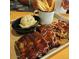 An inviting dinner selection with ribs, pulled pork, fries, and mashed potatoes at 1712 E Manhatton Dr, Tempe, AZ 85282