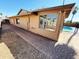 Tan single-story home showcasing a walkway, large window, and partial view of a refreshing pool at 1712 E Manhatton Dr, Tempe, AZ 85282