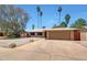 Charming single-story home with a two-car garage, low maintenance desert landscaping, and a welcoming entrance at 1712 E Manhatton Dr, Tempe, AZ 85282