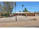Charming single-story home with a two-car garage, low maintenance desert landscaping, and a welcoming entrance at 1712 E Manhatton Dr, Tempe, AZ 85282