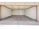 Spacious two-car garage with white brick walls and lighting at 1712 E Manhatton Dr, Tempe, AZ 85282