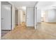 Open hallway view featuring tan tile flooring, white doors, and neutral paint throughout the interior space at 1712 E Manhatton Dr, Tempe, AZ 85282