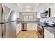Modern kitchen with stainless steel appliances, white cabinets, and natural lighting at 1712 E Manhatton Dr, Tempe, AZ 85282