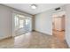 Bright living room with tiled floor and sliding door to the sunroom at 1712 E Manhatton Dr, Tempe, AZ 85282