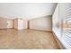 Bright living room with tile flooring, neutral walls, and a view of the entryway at 1712 E Manhatton Dr, Tempe, AZ 85282