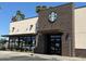 The front exterior of a modern Starbucks building with brick and sand colored accents at 1712 E Manhatton Dr, Tempe, AZ 85282
