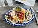 Three colorful tacos on a plate with various toppings, perfect for a casual and delicious meal at 1712 E Manhatton Dr, Tempe, AZ 85282