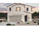 Charming two-story home with stucco siding, tile roof, and a two-car garage at 17223 W Daley Ln, Surprise, AZ 85387