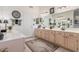 Bright bathroom featuring double sinks, ample counter space, decorative mirrors, and tiled floors at 17543 N Rainbow Cir, Surprise, AZ 85374