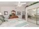 Cozy bedroom featuring a mirrored closet door, dresser, ceiling fan and lots of light at 17543 N Rainbow Cir, Surprise, AZ 85374