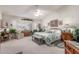 Bright, spacious bedroom features a ceiling fan, upholstered chairs, large windows and decorative bedding at 17543 N Rainbow Cir, Surprise, AZ 85374