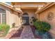 Charming entryway featuring a brick walkway, desert landscaping, and a decorative metal door at 17543 N Rainbow Cir, Surprise, AZ 85374