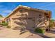 Tan single-story home with desert landscaping and a two-car garage at 17543 N Rainbow Cir, Surprise, AZ 85374