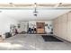 Spacious garage with tool bench, cabinet storage, and ample room for parking and projects at 17543 N Rainbow Cir, Surprise, AZ 85374