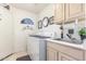 Functional laundry room featuring sink, upper and lower cabinets and washer and dryer at 17543 N Rainbow Cir, Surprise, AZ 85374