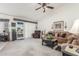 Comfortable living area with a ceiling fan, plush seating, and access to the patio at 17543 N Rainbow Cir, Surprise, AZ 85374