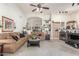 Spacious living room with sofas, neutral decor, and seamless transition to the kitchen at 17543 N Rainbow Cir, Surprise, AZ 85374
