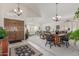 Open-concept living room featuring tile floors, large windows, and a vaulted ceiling at 17543 N Rainbow Cir, Surprise, AZ 85374