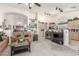 Open-concept living area flowing into the kitchen with bar-style seating and neutral tones at 17543 N Rainbow Cir, Surprise, AZ 85374
