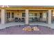 Covered patio with ceiling fan, comfortable seating, and a beautiful view of the backyard landscaping at 17543 N Rainbow Cir, Surprise, AZ 85374