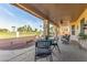 Relaxing covered patio, perfect for outdoor dining with a scenic view of a well-maintained yard at 17543 N Rainbow Cir, Surprise, AZ 85374