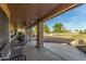 Inviting covered patio offering ample seating and scenic views of the lush green landscape at 17543 N Rainbow Cir, Surprise, AZ 85374