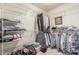 Organized walk-in closet with shelving and hanging racks provides plenty of storage space at 17543 N Rainbow Cir, Surprise, AZ 85374