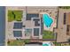 Aerial view of home with solar panels on roof and a sparkling in-ground swimming pool in the backyard at 1755 N 74 Th Pl, Mesa, AZ 85207