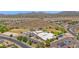 Aerial view showcasing a community school, parking lot, athletic field, and surrounding neighborhood at 1755 N 74 Th Pl, Mesa, AZ 85207