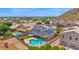 Aerial view of home with solar panels on roof and a sparkling in-ground swimming pool in the backyard at 1755 N 74 Th Pl, Mesa, AZ 85207
