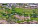 Aerial view of neighborhood park with mature trees, playground, and green spaces at 1755 N 74 Th Pl, Mesa, AZ 85207