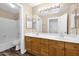 Bathroom featuring a double vanity, neutral color palette, and a shower and bathtub combo at 1755 N 74 Th Pl, Mesa, AZ 85207