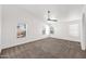 A large bedroom with vaulted ceilings, ceiling fan, and multiple windows offering natural light at 1755 N 74 Th Pl, Mesa, AZ 85207