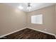 This bedroom features wood floors, a ceiling fan, and a light beige paint at 1755 N 74 Th Pl, Mesa, AZ 85207