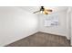 Comfortable bedroom with neutral carpeting, ceiling fan, and a window for natural light at 1755 N 74 Th Pl, Mesa, AZ 85207