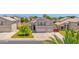 Charming two-story home features a well-manicured lawn, mature trees, and a spacious two-car garage at 1755 N 74 Th Pl, Mesa, AZ 85207