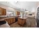 Spacious kitchen featuring wood cabinetry, an island with a breakfast bar, and stainless steel appliances at 1755 N 74 Th Pl, Mesa, AZ 85207