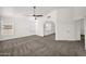 A bright living area featuring carpeting and plenty of natural light from multiple windows at 1755 N 74 Th Pl, Mesa, AZ 85207