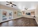 Bright living room featuring wood-look floors, neutral walls, ceiling fans, and access to the backyard at 1755 N 74 Th Pl, Mesa, AZ 85207