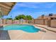 Inviting backyard pool with diving board, surrounded by a concrete deck and mature landscaping at 1755 N 74 Th Pl, Mesa, AZ 85207