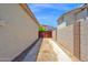 Side yard with block wall fence and a view of a back gate for privacy at 1755 N 74 Th Pl, Mesa, AZ 85207