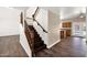 Dark wood staircase with views to the kitchen and pool area through sliding glass doors at 1755 N 74 Th Pl, Mesa, AZ 85207