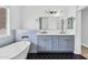 Modern bathroom includes a freestanding tub, large mirror, and dual sink vanity at 18998 E Lark Dr, Queen Creek, AZ 85142
