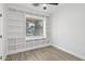 Bright bedroom featuring built-in shelving, neutral paint, recessed lights, and luxury vinyl plank flooring at 18998 E Lark Dr, Queen Creek, AZ 85142