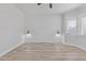 Bedroom with stylish wainscoting and neutral floors, lit with modern sconces at 18998 E Lark Dr, Queen Creek, AZ 85142