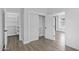 Bright closet area featuring built-in shelving and luxury vinyl plank flooring at 18998 E Lark Dr, Queen Creek, AZ 85142