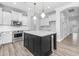 Spacious kitchen featuring stainless steel appliances, a center island, and ample countertop space at 18998 E Lark Dr, Queen Creek, AZ 85142