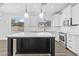 Modern kitchen features a large island, white cabinets, and luxury vinyl plank flooring at 18998 E Lark Dr, Queen Creek, AZ 85142